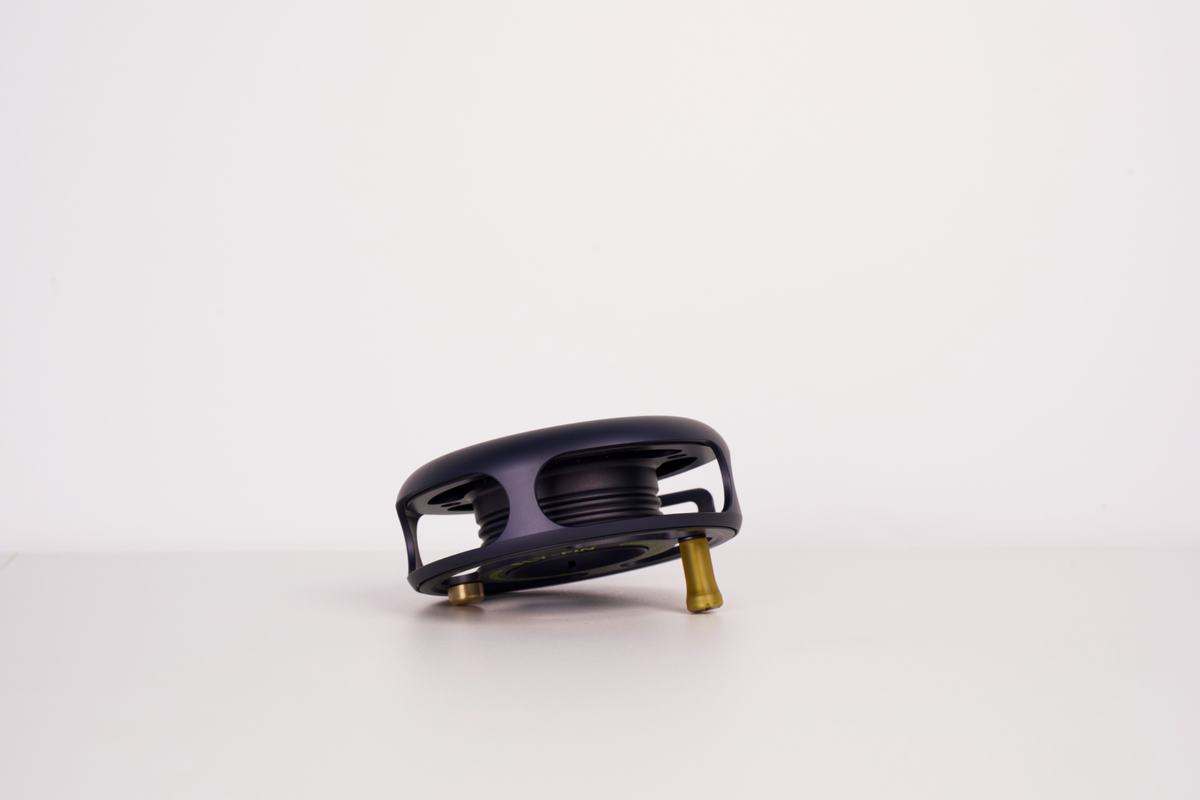 Actual Fly-Fin reel photograph showing the open centre, grooved spool and winding grip.
